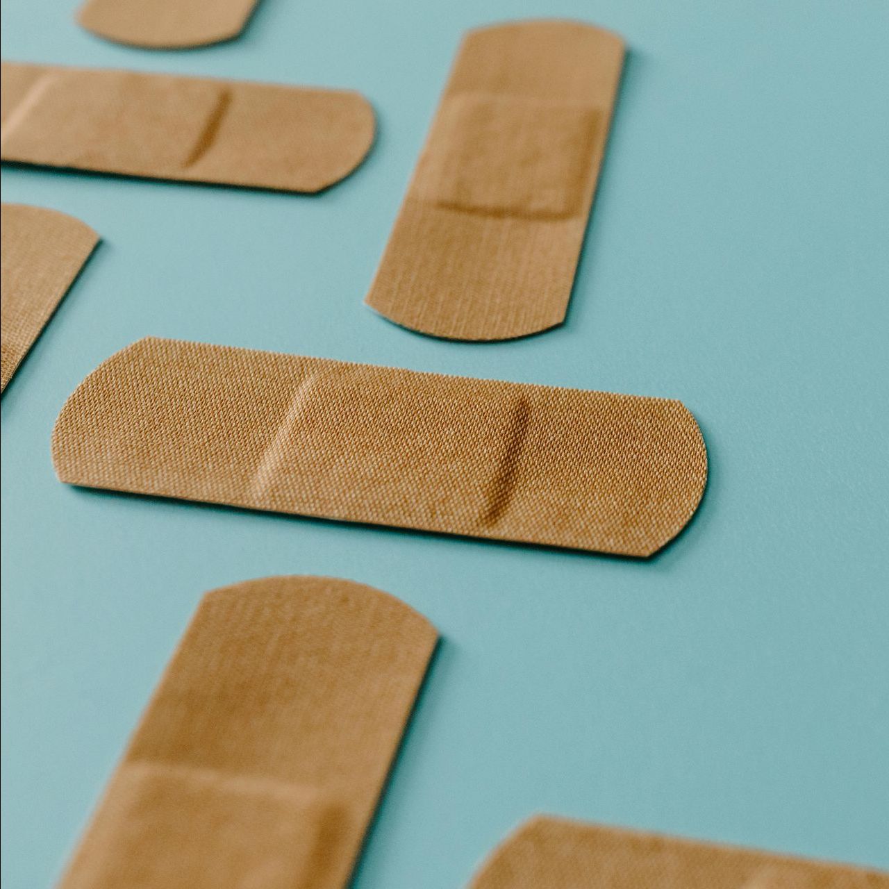 A close up of a bunch of bandages on a blue surface.