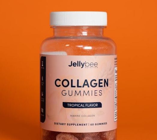 A bottle of jellypee collagen gummies on an orange background.