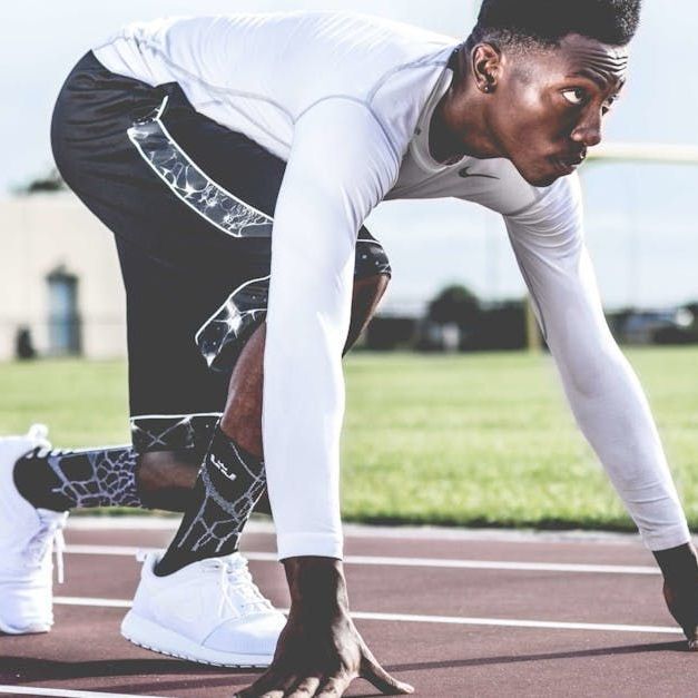 A man is getting ready to run on a track