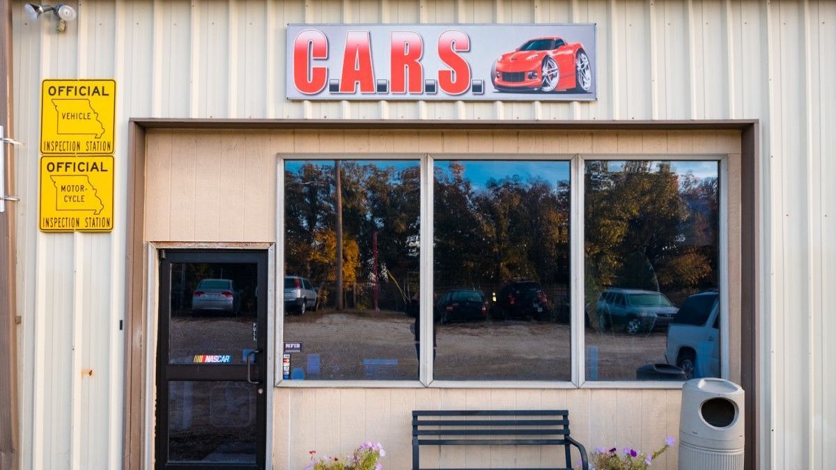 a building with a sign that says cars on it