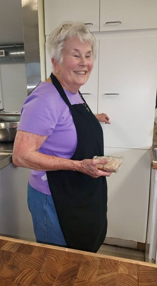 Woman Holding a Sandwich — Montrose, CO — The Shepherd’s Hand