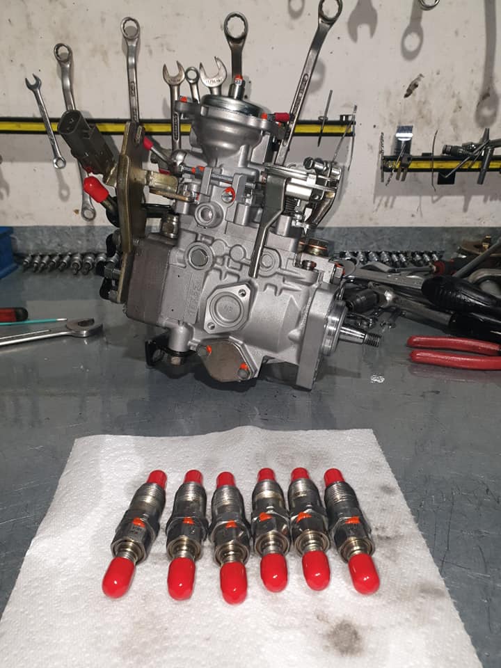 A Fuel Pump Is Sitting On A Table Next To Some Red Caps — Hastings Diesel Service In Wauchope, NSW