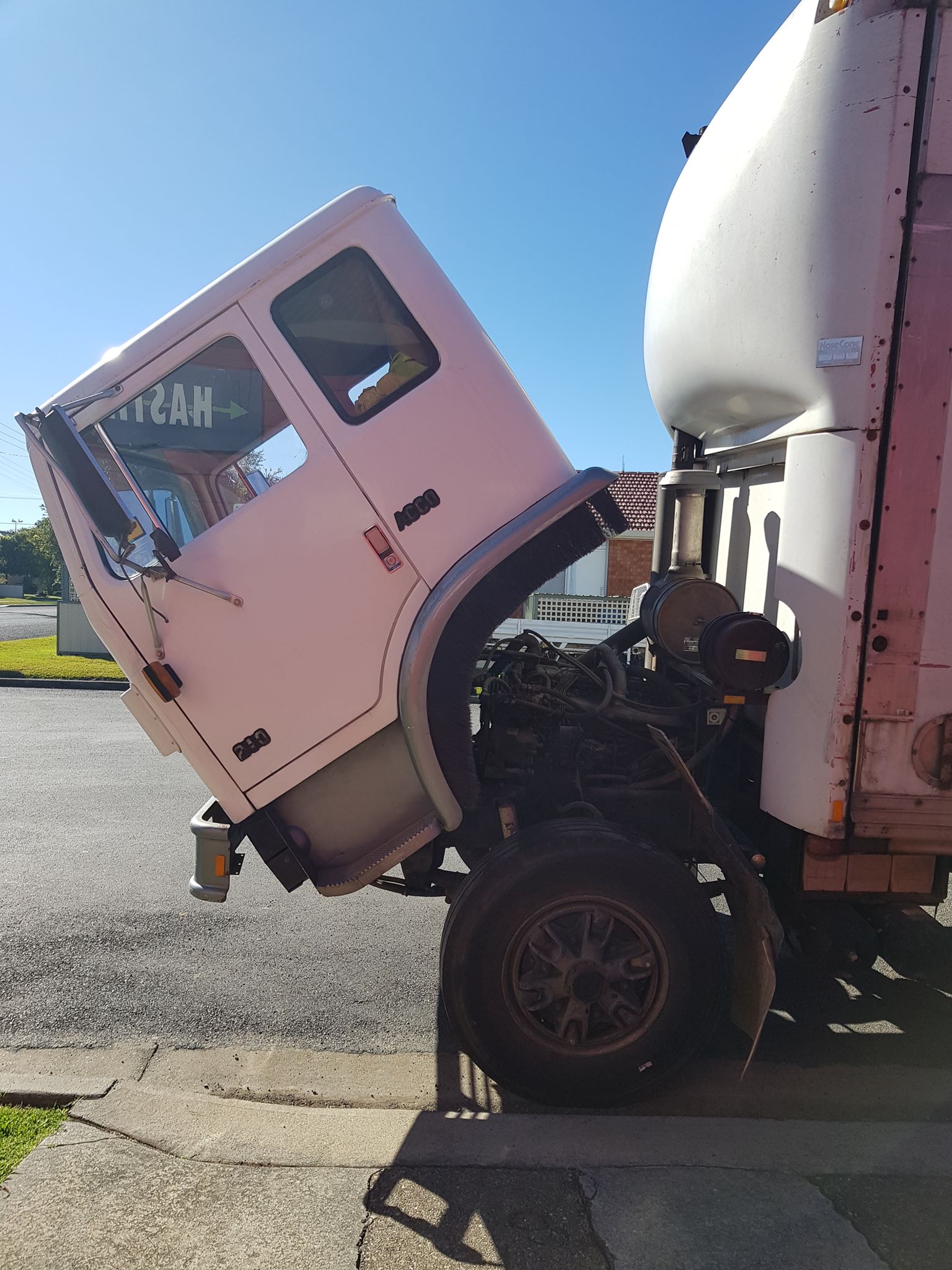 A White Truck With The Cab Up Is Parked On The Side Of The Road — Hastings Diesel Service In Wauchope, NSW