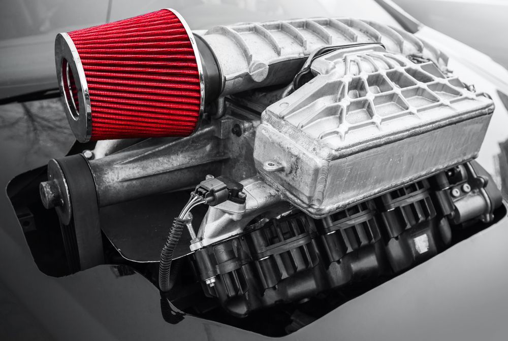 A Black And White Photo Of A Car Engine With A Red Filter Attached To It — Hastings Diesel Service In Wauchope, NSW