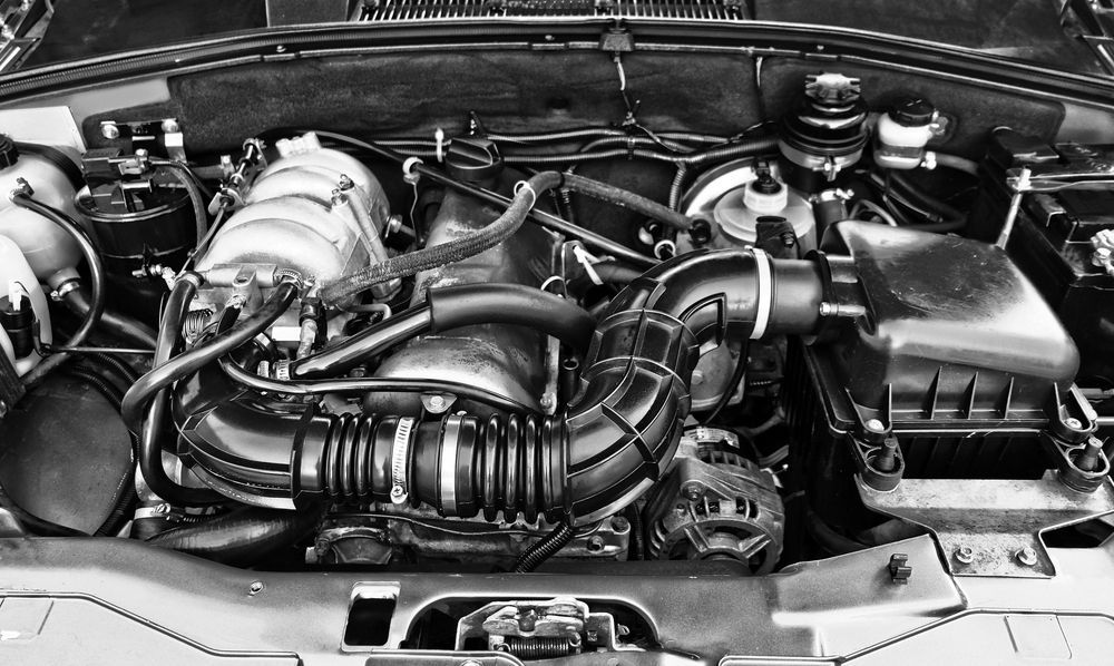 A black and white photo of a car engine with the hood open — Hastings Diesel Service In Port Macquarie, NSW