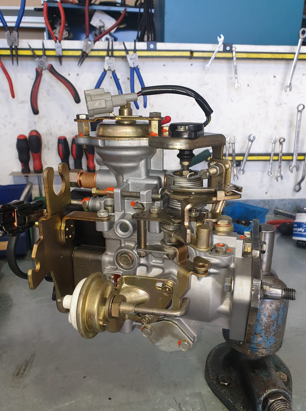 A Carburetor Is Sitting On A Table In A Garage — Hastings Diesel Service In Wauchope, NSW