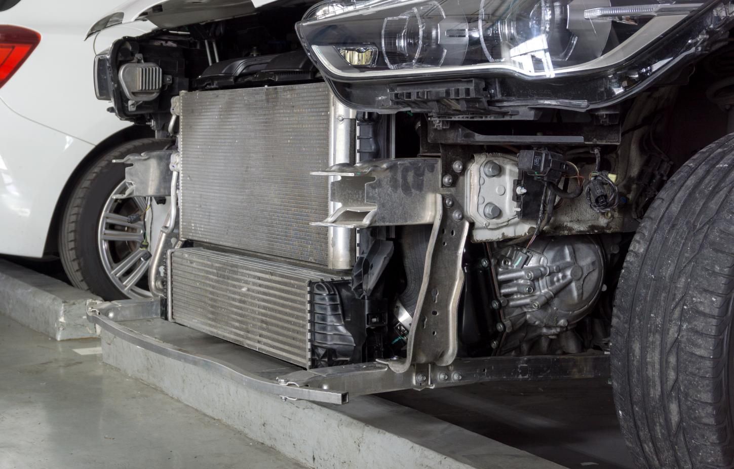 A White Car With Its Radiator Removed Is Parked In A Parking Garage — Hastings Diesel Service In Wauchope, NSW