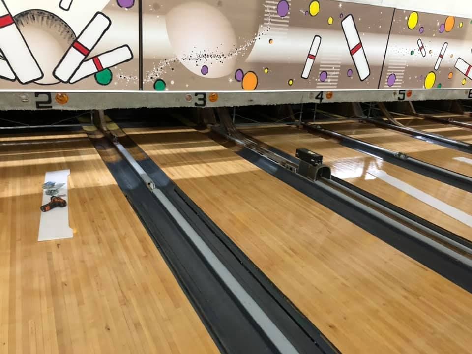 A bowling alley with a picture of bowling pins on it