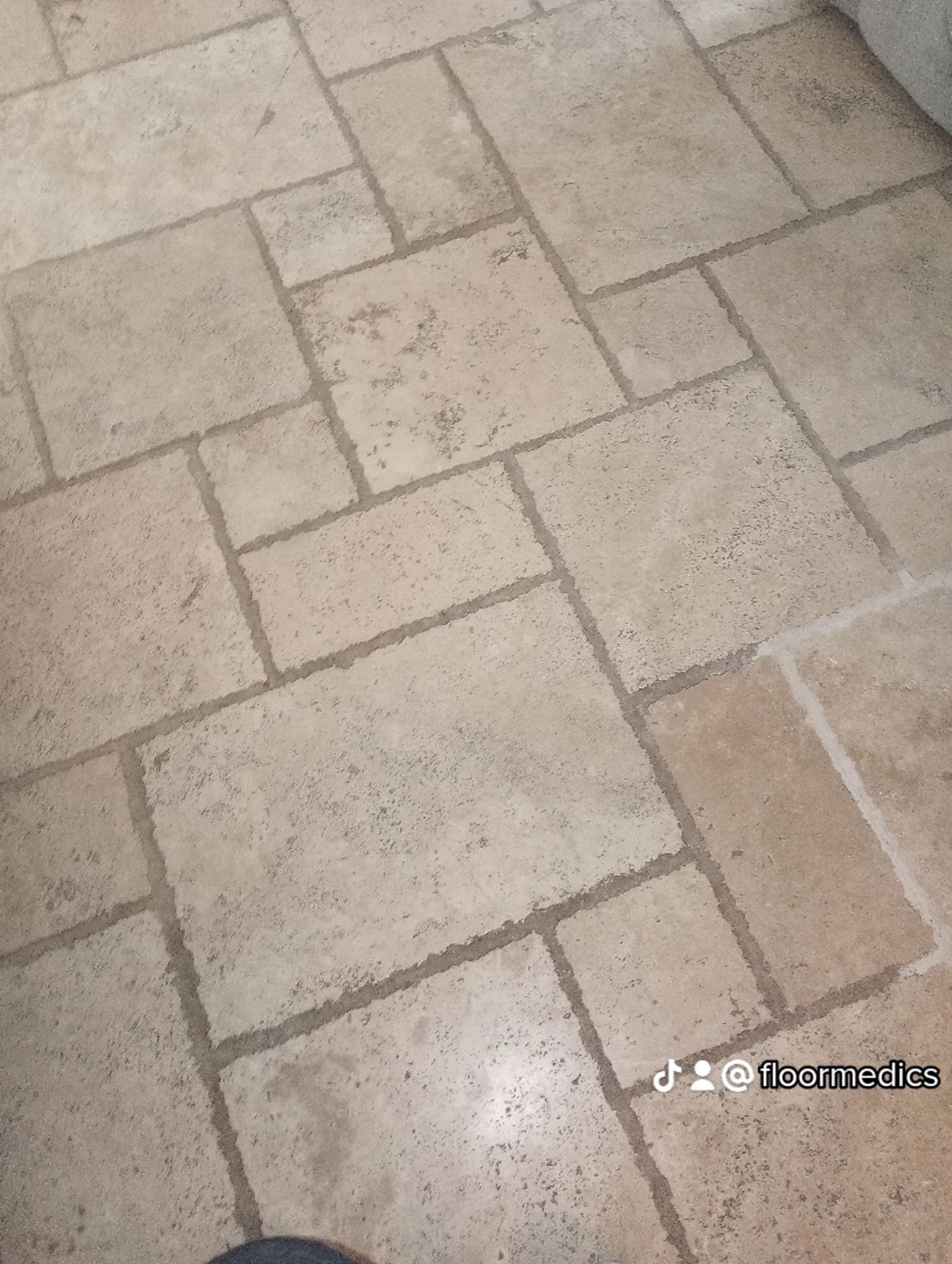 A close up of a tiled floor with a geometric pattern.