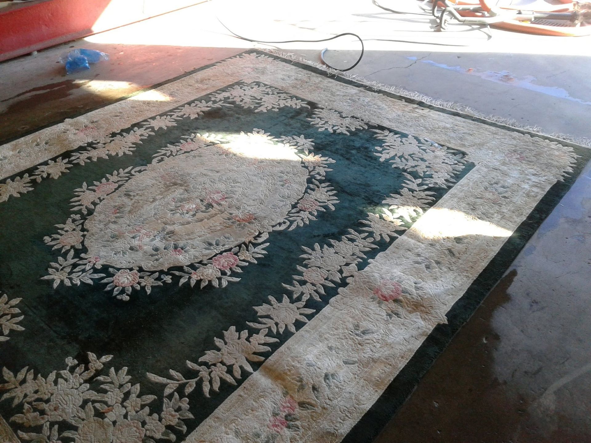A rug with a floral pattern is sitting on the floor