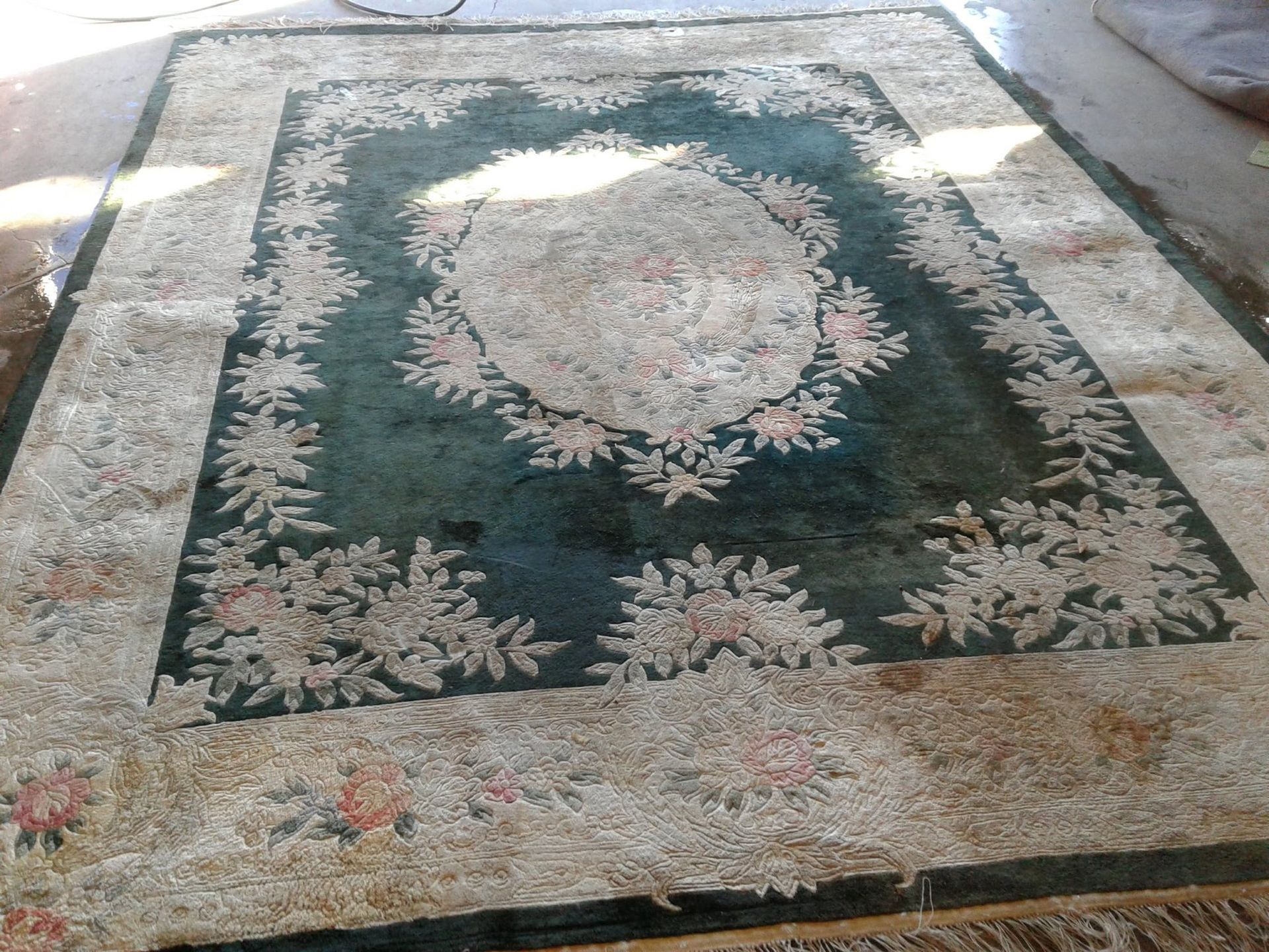 A rug with a floral pattern on it is sitting on a table.
