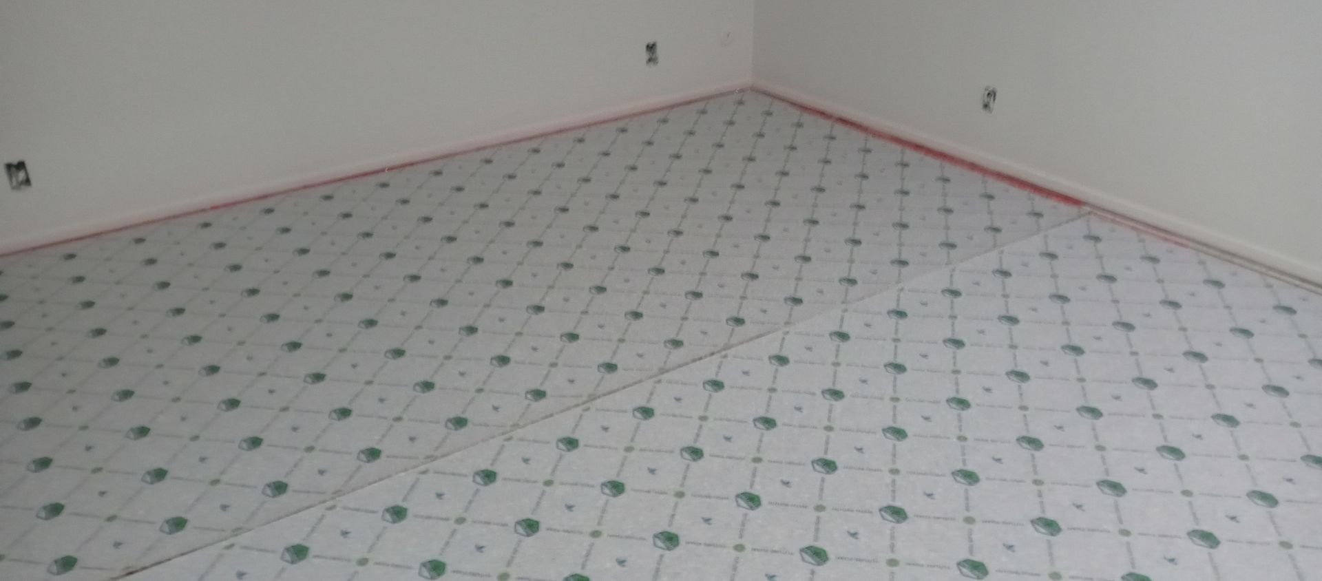 A room with a carpeted floor and white walls.