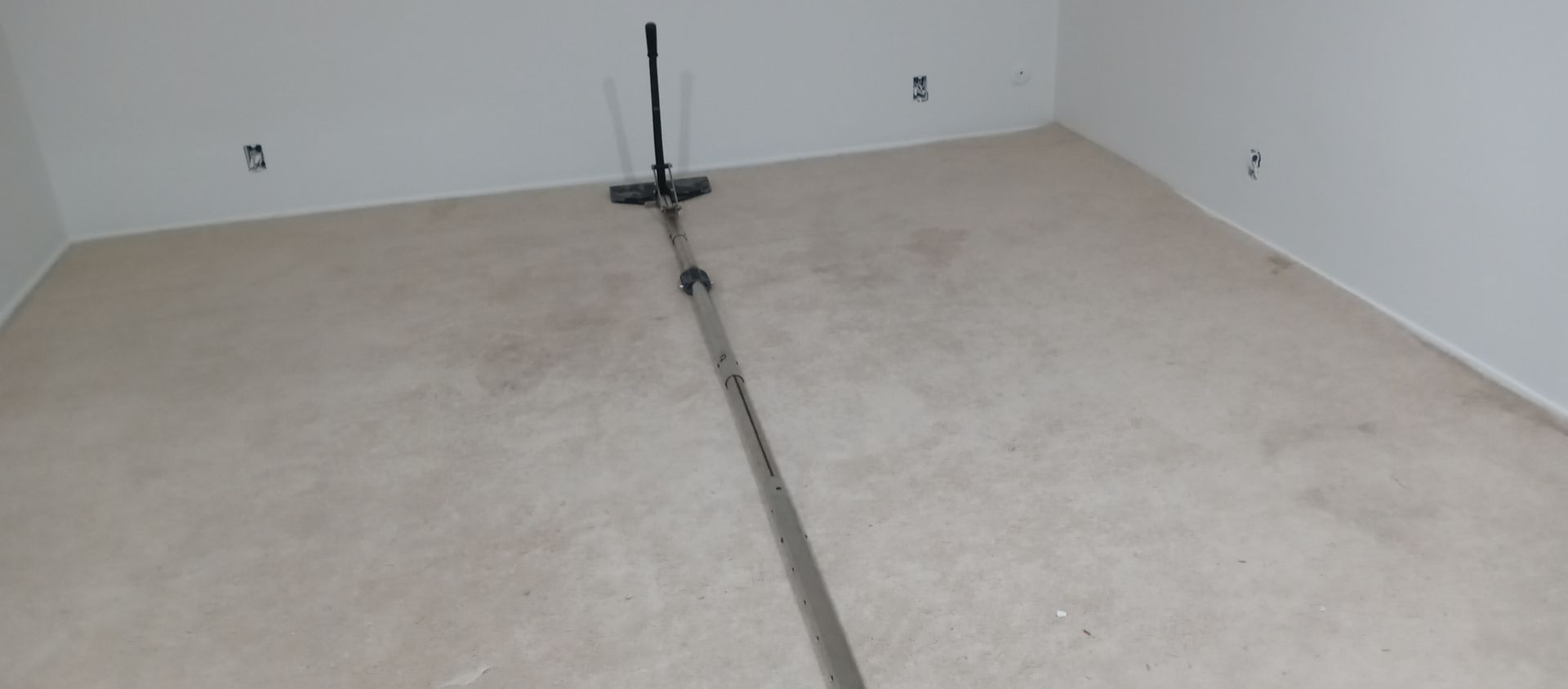 There is a vacuum cleaner in the middle of the room.