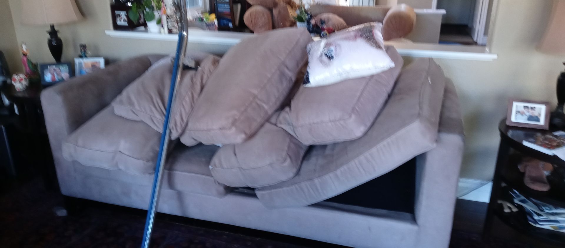 A couch with a lot of pillows on it in a living room