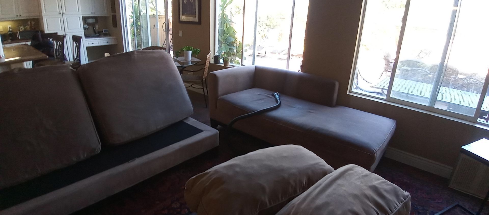 A living room with a couch and a chaise lounge