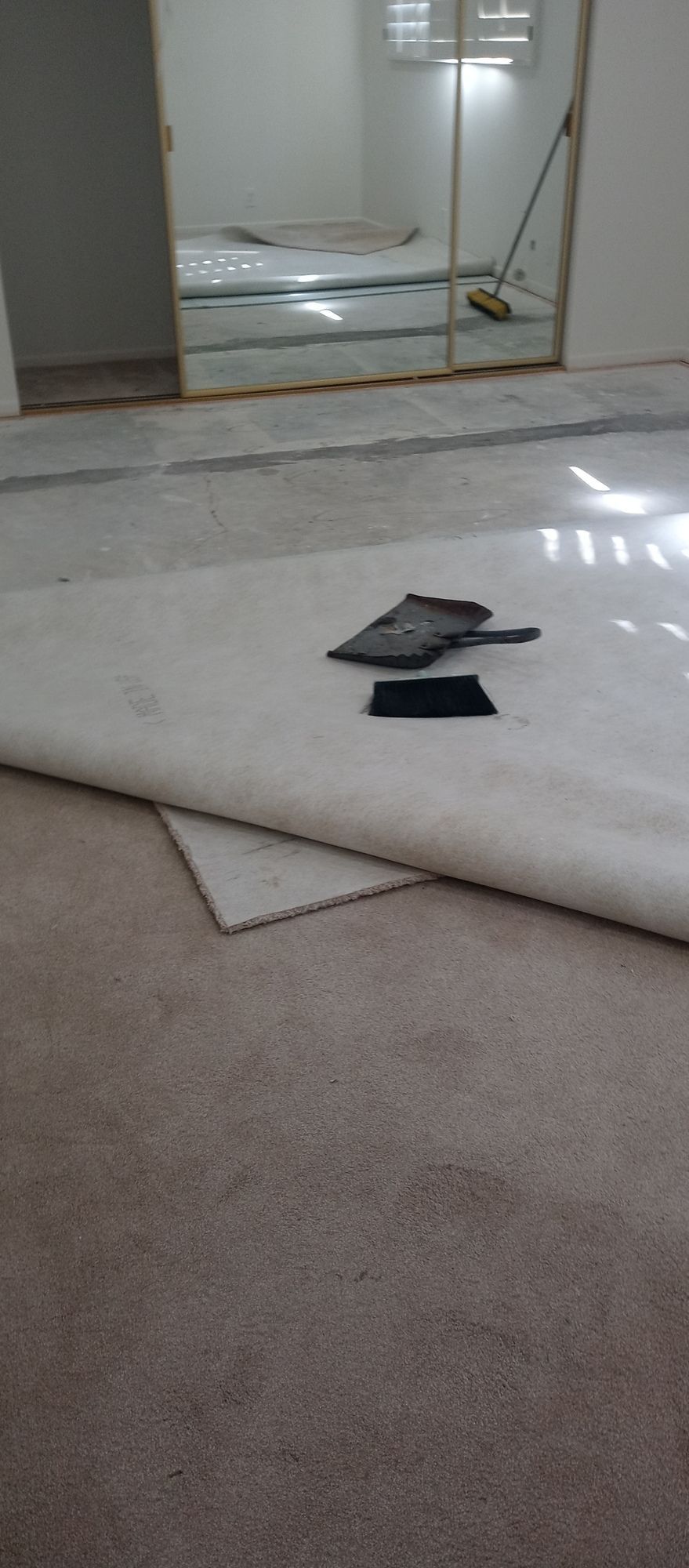 A piece of carpet is laying on the floor in a room.