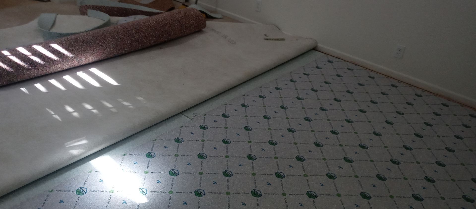 A roll of carpet is sitting on top of a white table.