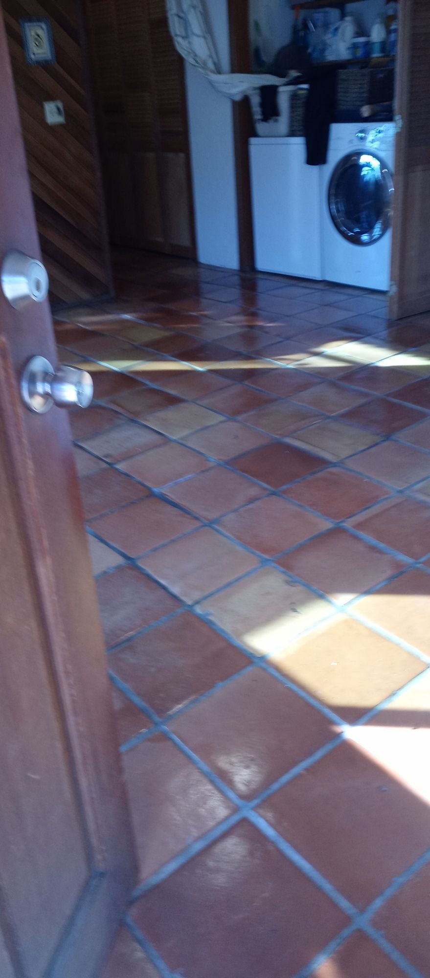 A laundry room with a washer and dryer and a tiled floor.