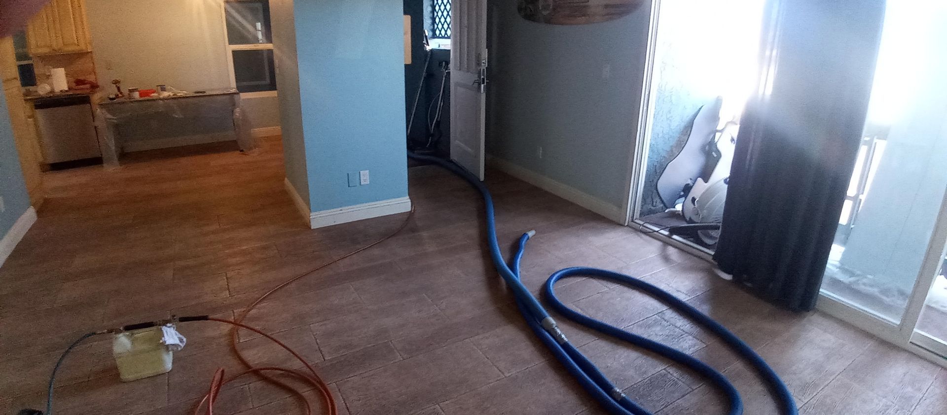 There is a vacuum hose in the middle of the room.