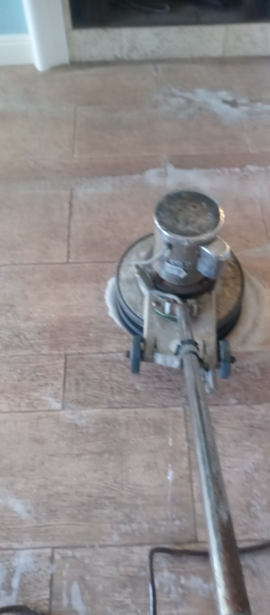 A machine is being used to polish a wooden floor.