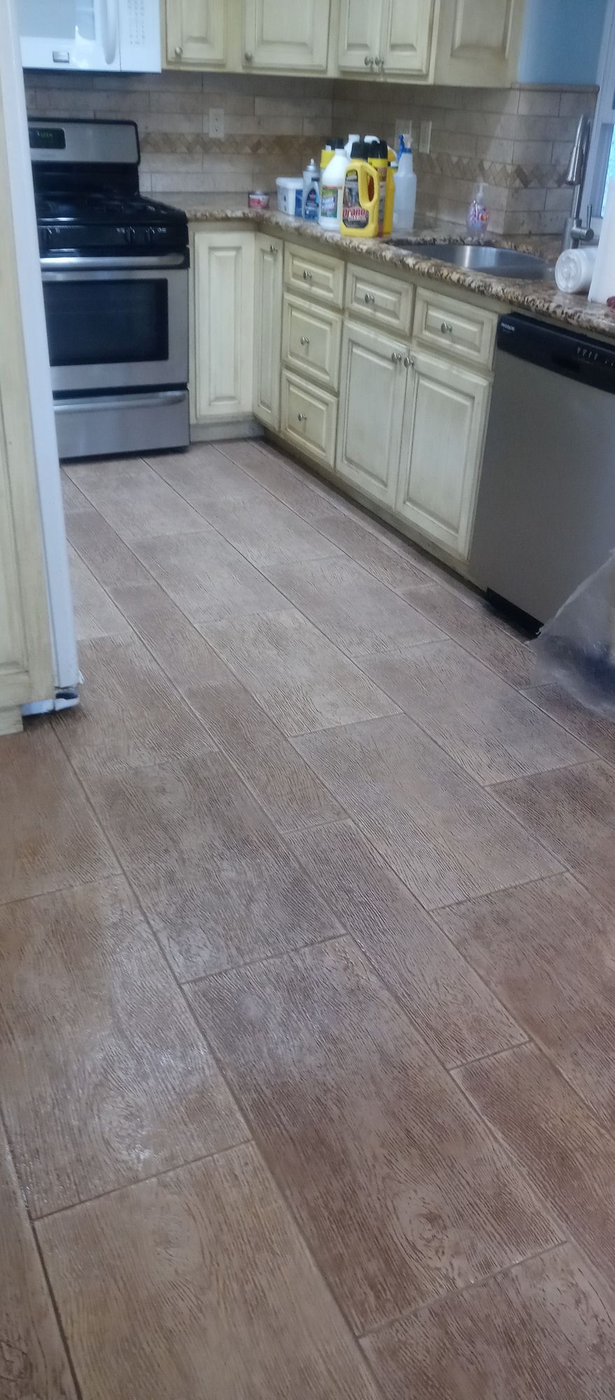 A kitchen with a stove , sink , and dishwasher.