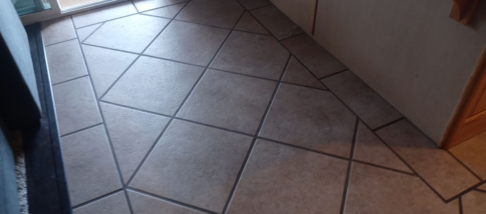A close up of a tiled floor in a kitchen.