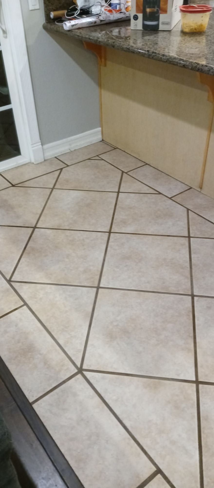 A kitchen with a tile floor and a granite counter top.