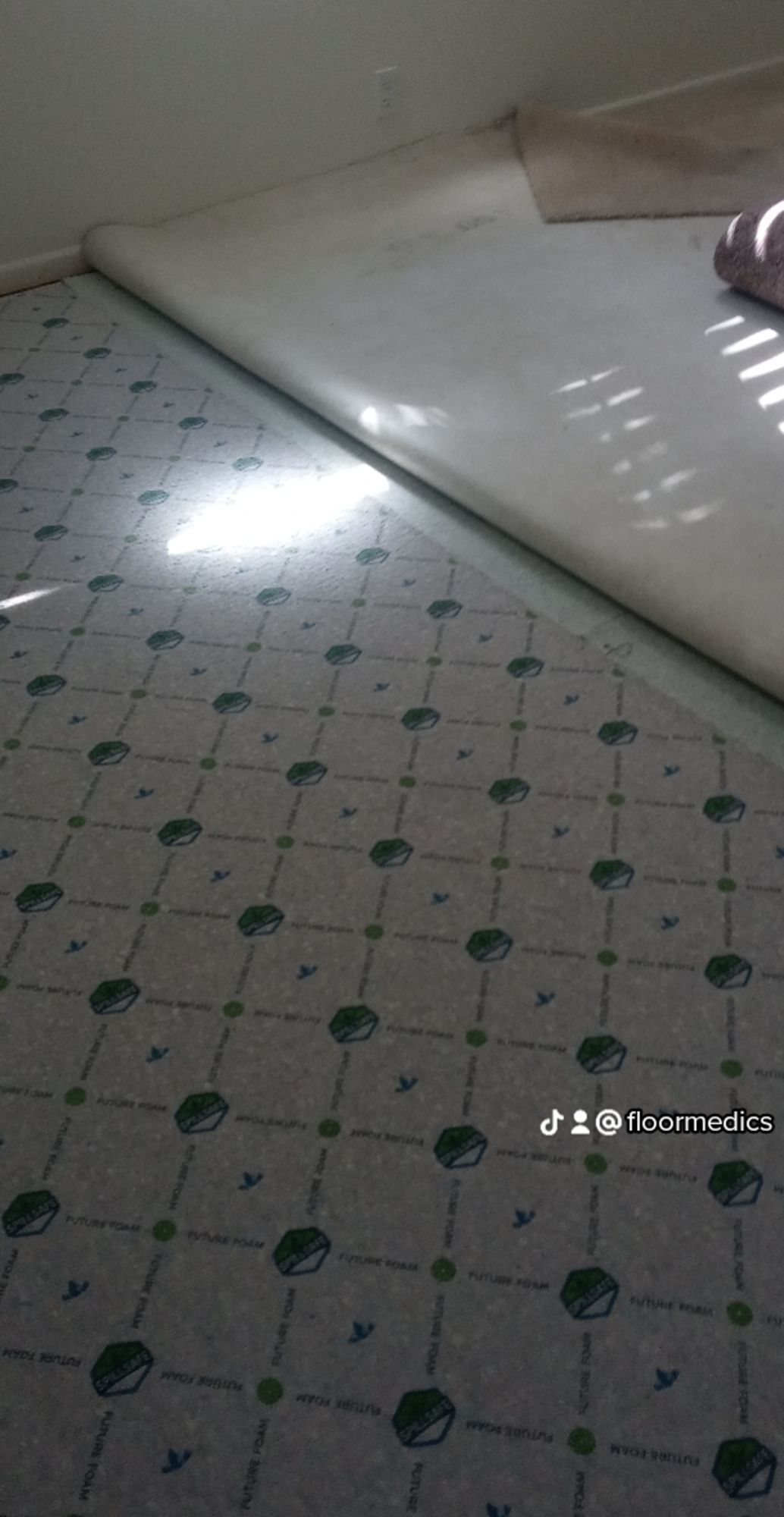 A piece of carpet is laying on the floor in a room.