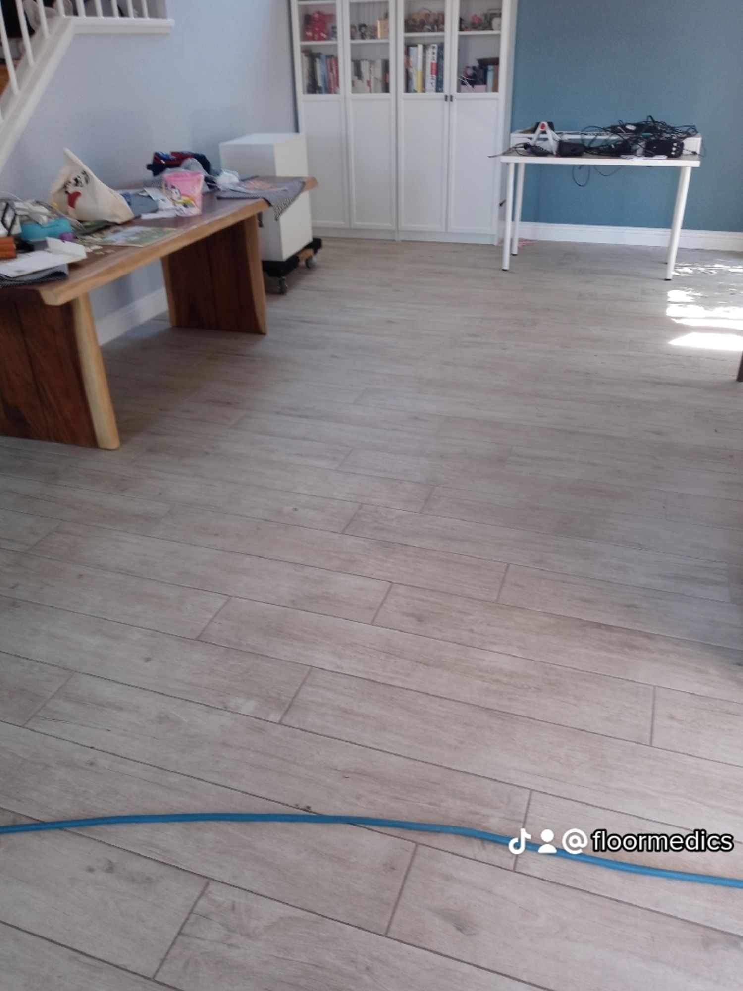 A living room with a wooden floor and a table