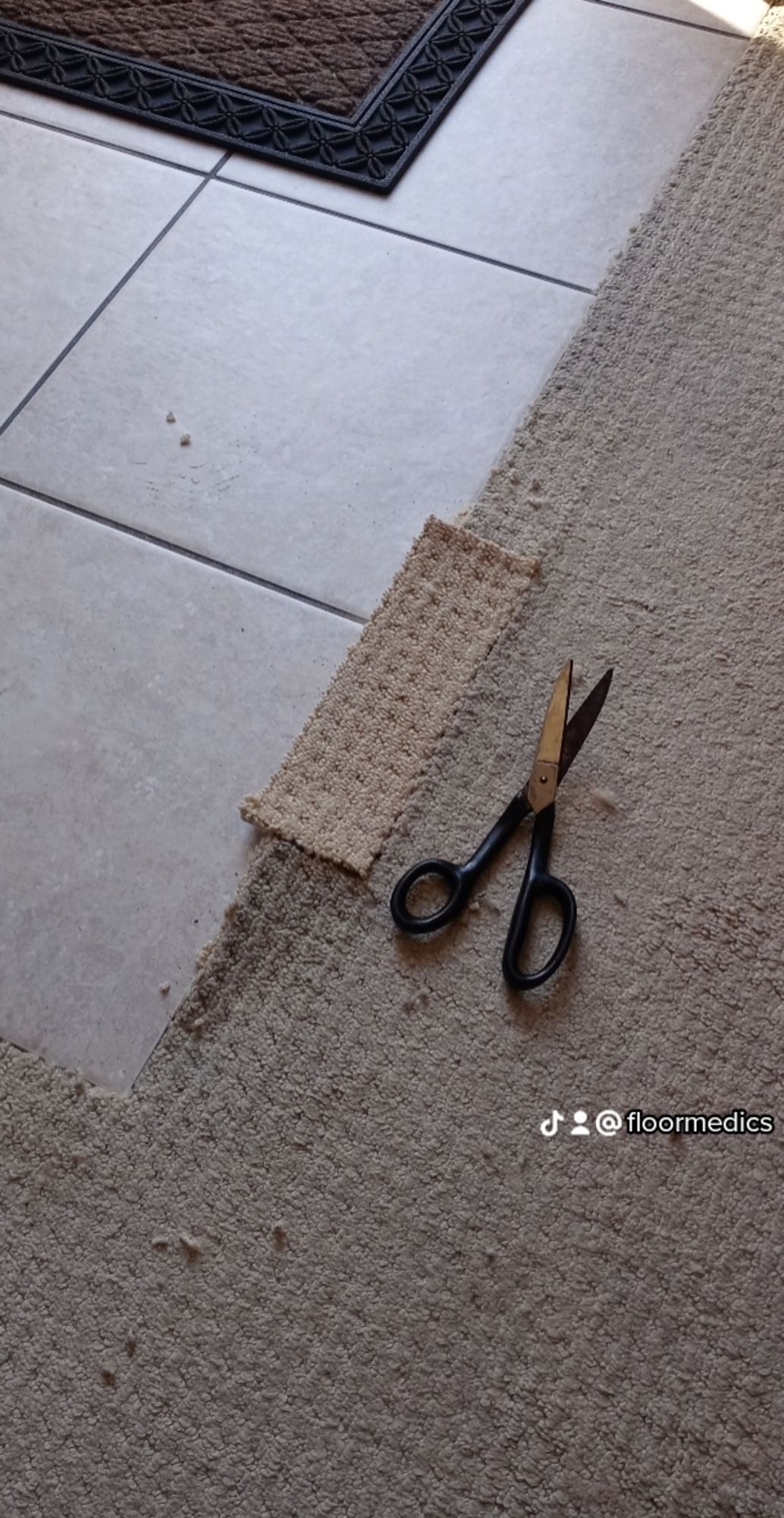 A pair of scissors sitting on top of a carpet.
