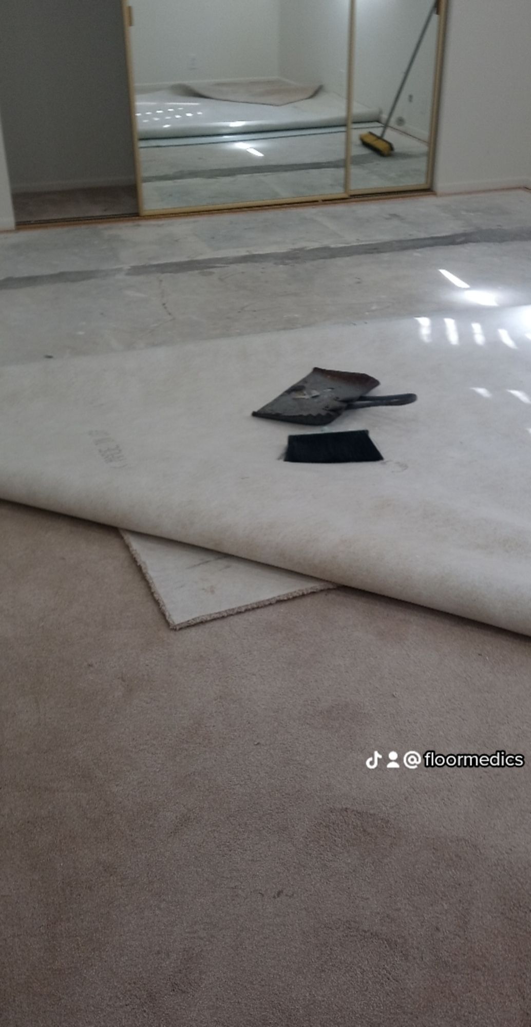 A piece of carpet is laying on the floor in a room.