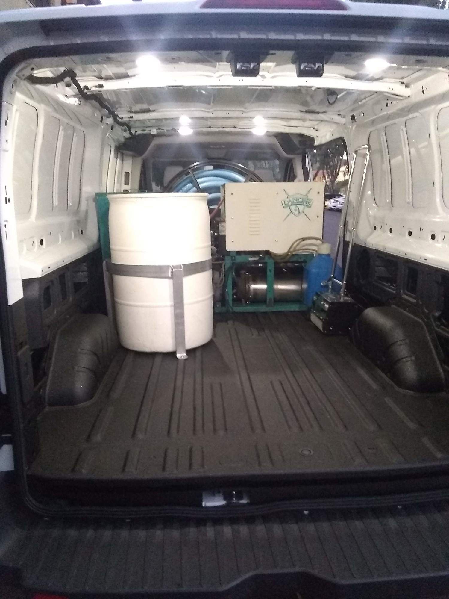 The back of a van with two barrels in it
