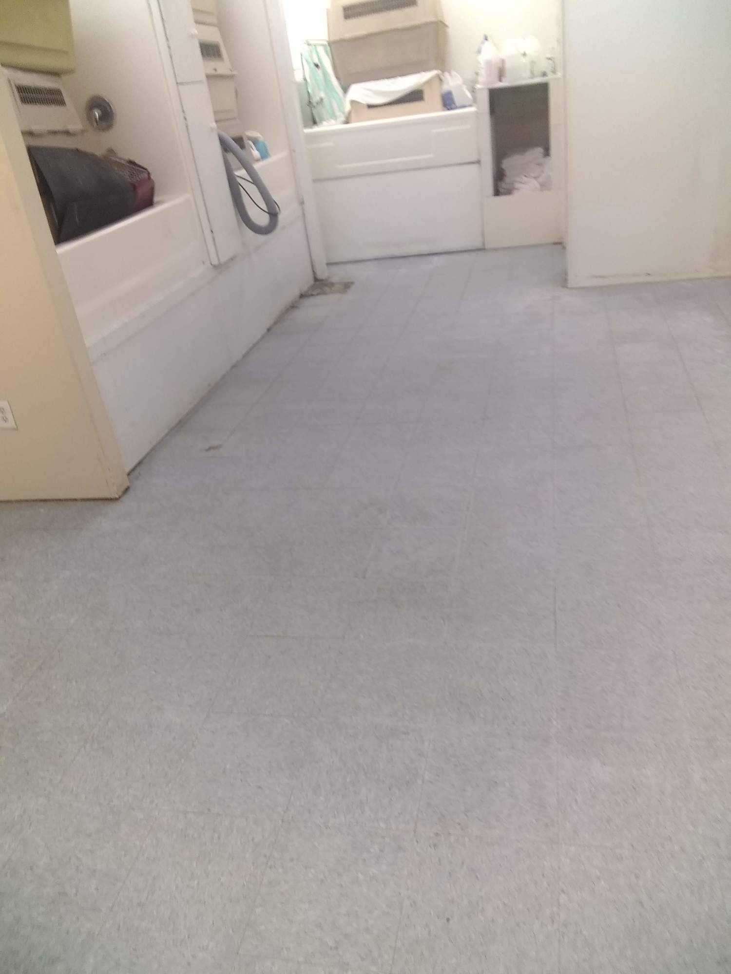 A bathroom with a bathtub and a washer and dryer