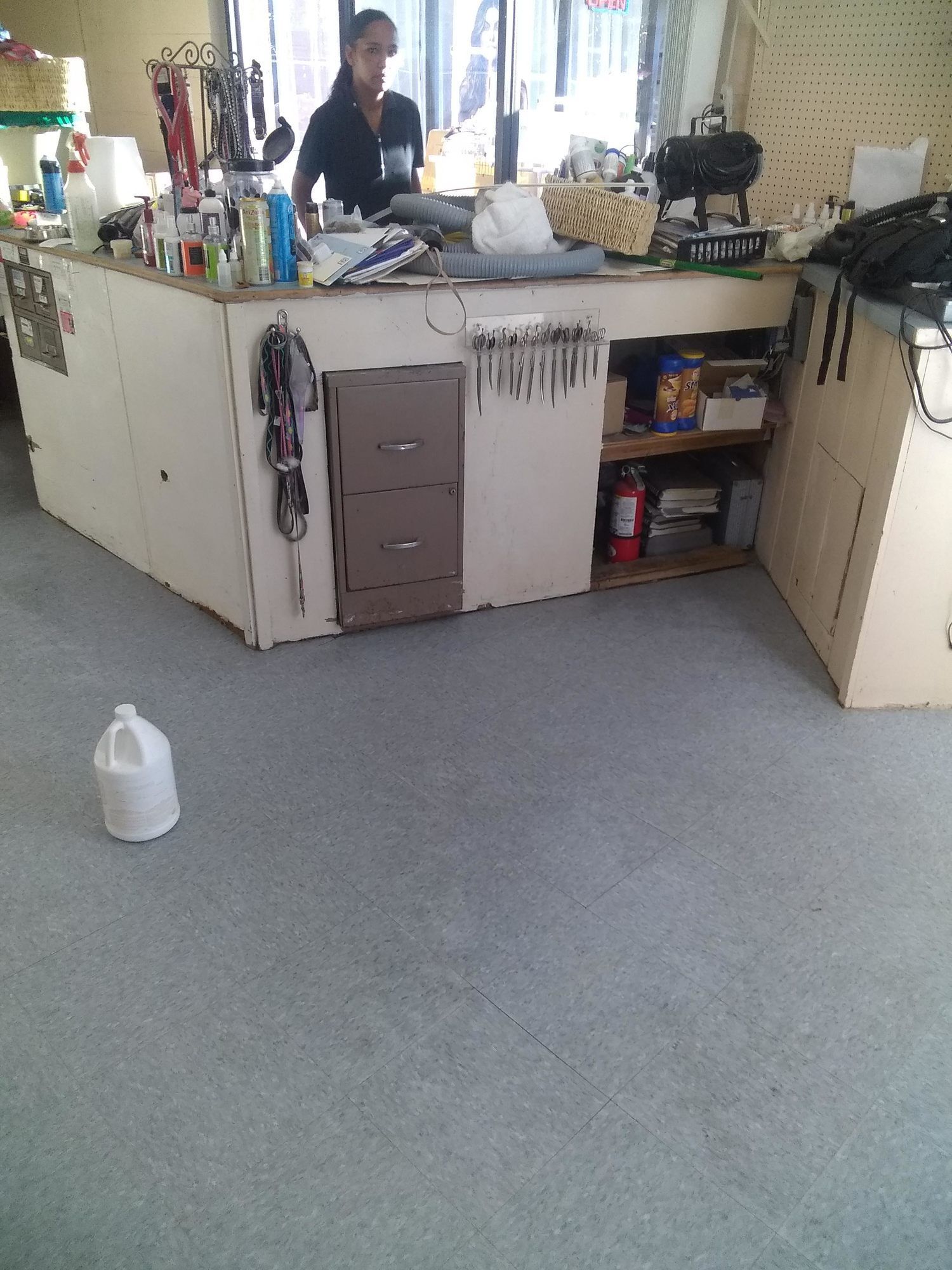A woman stands behind a counter in a store