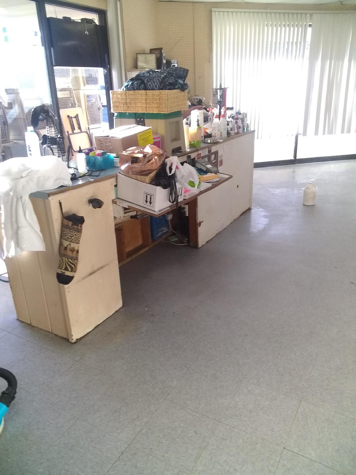 A room with a lot of boxes on the floor and a table.