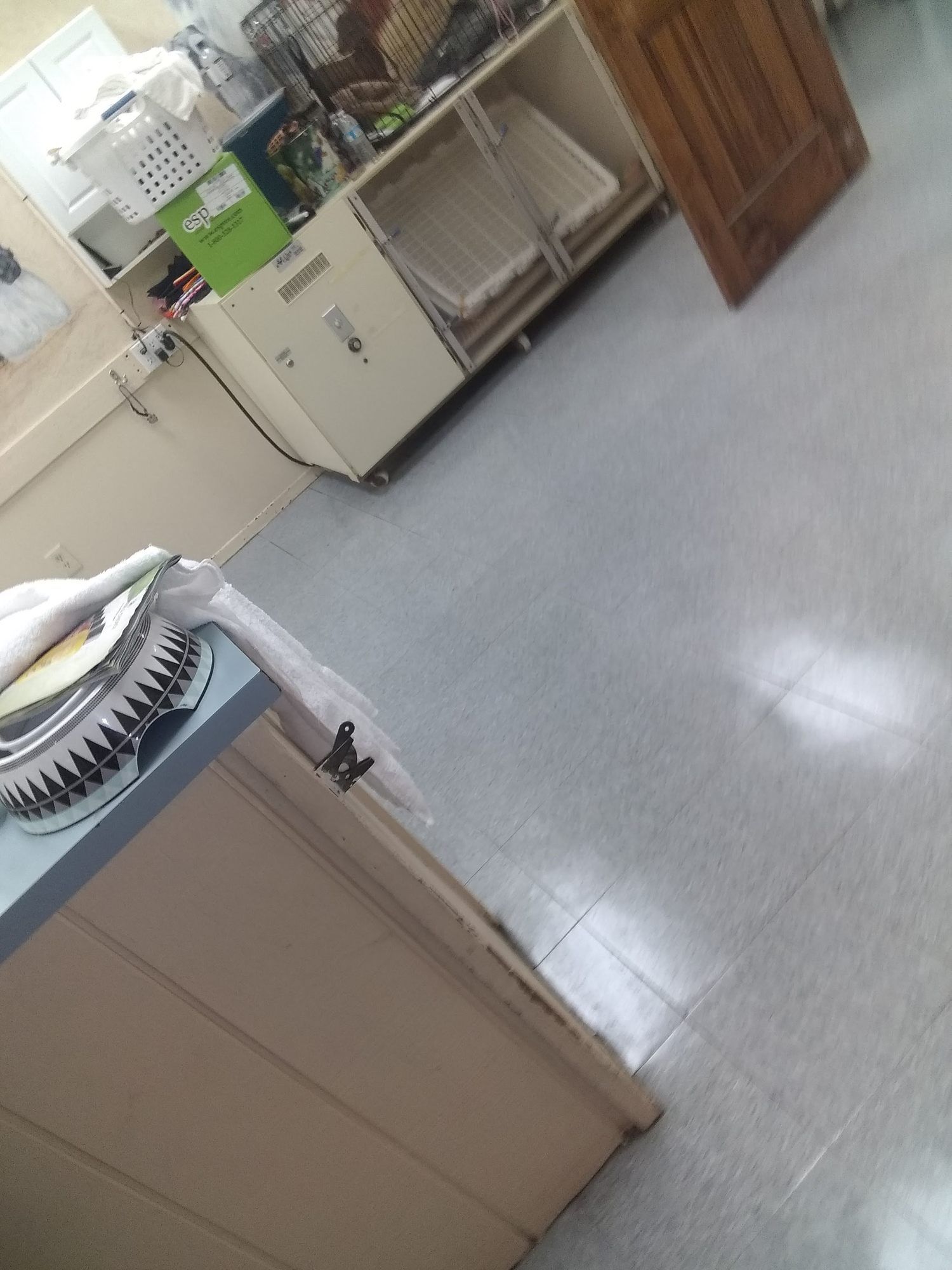 A kitchen with a stove , sink , cabinets and a door.