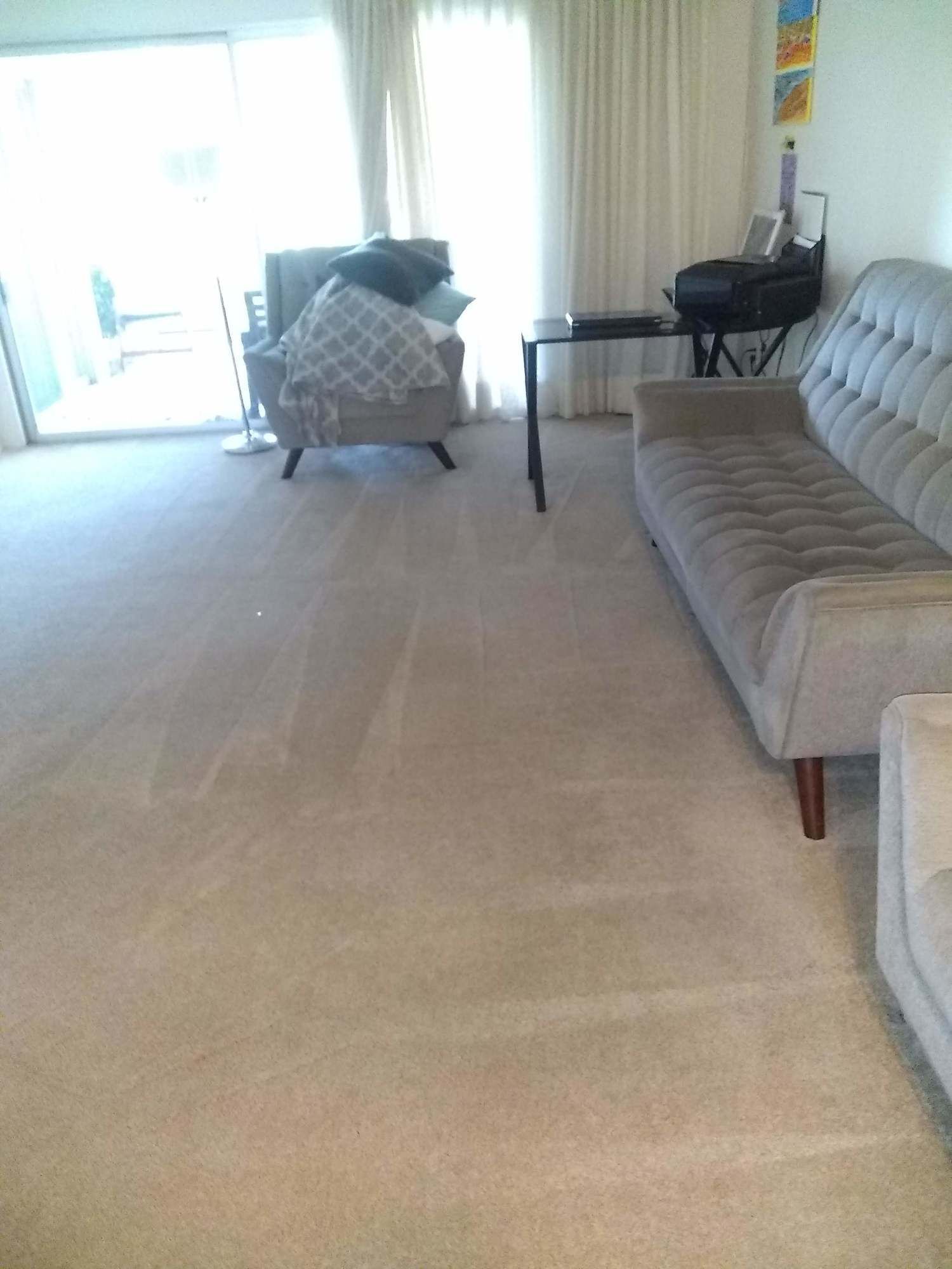 A living room with a couch , chair and table.