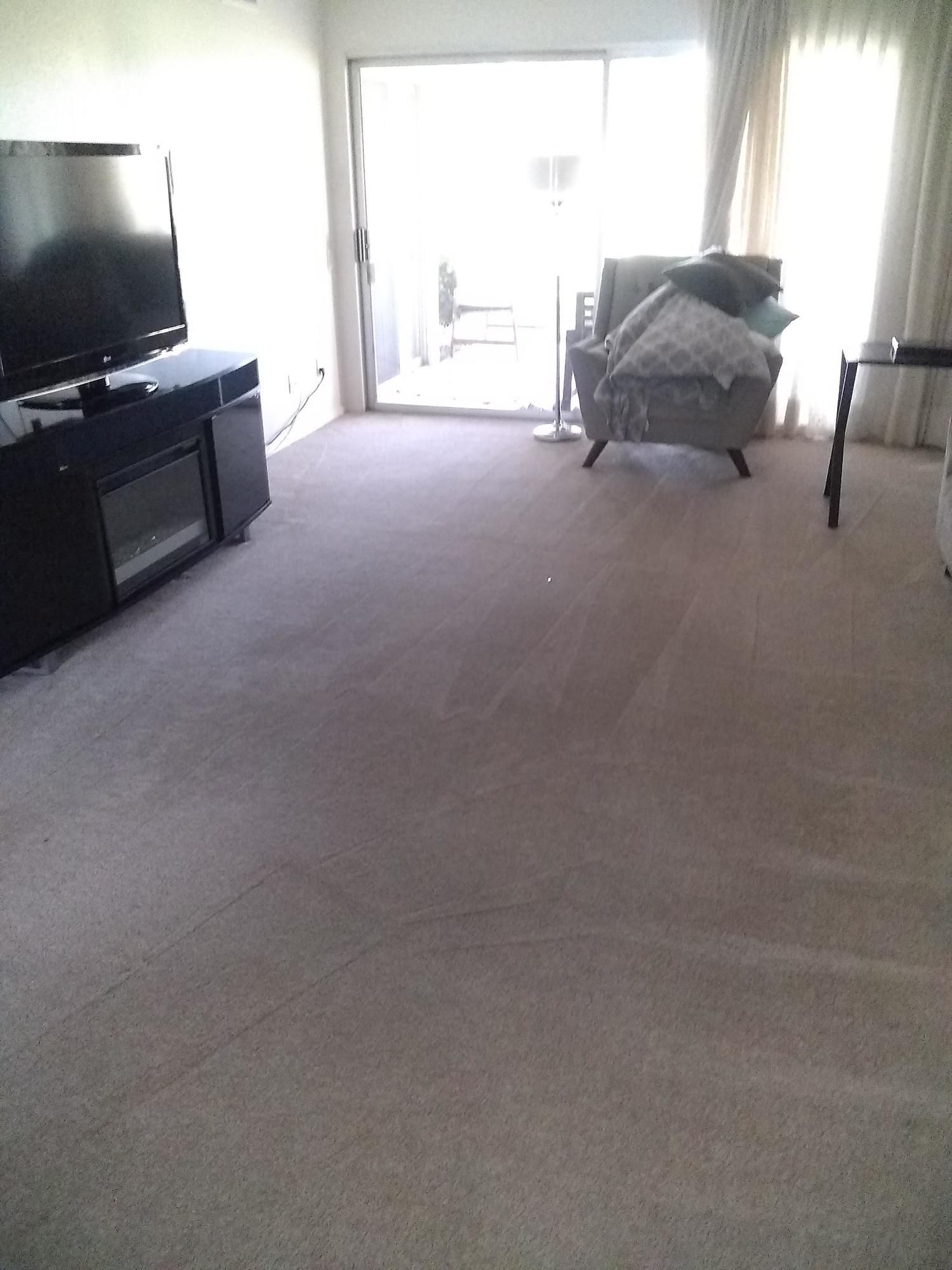 A living room with a chair and a flat screen tv