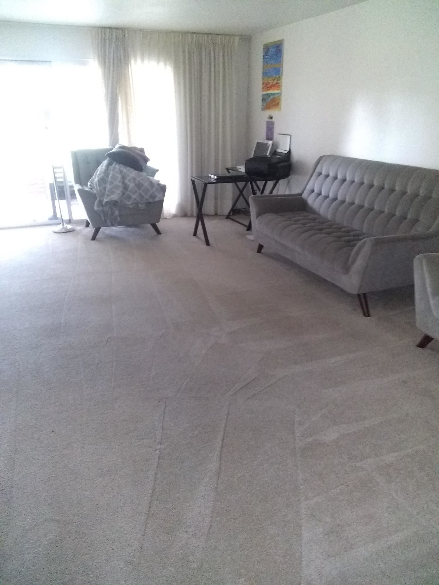 A living room with a couch and two chairs