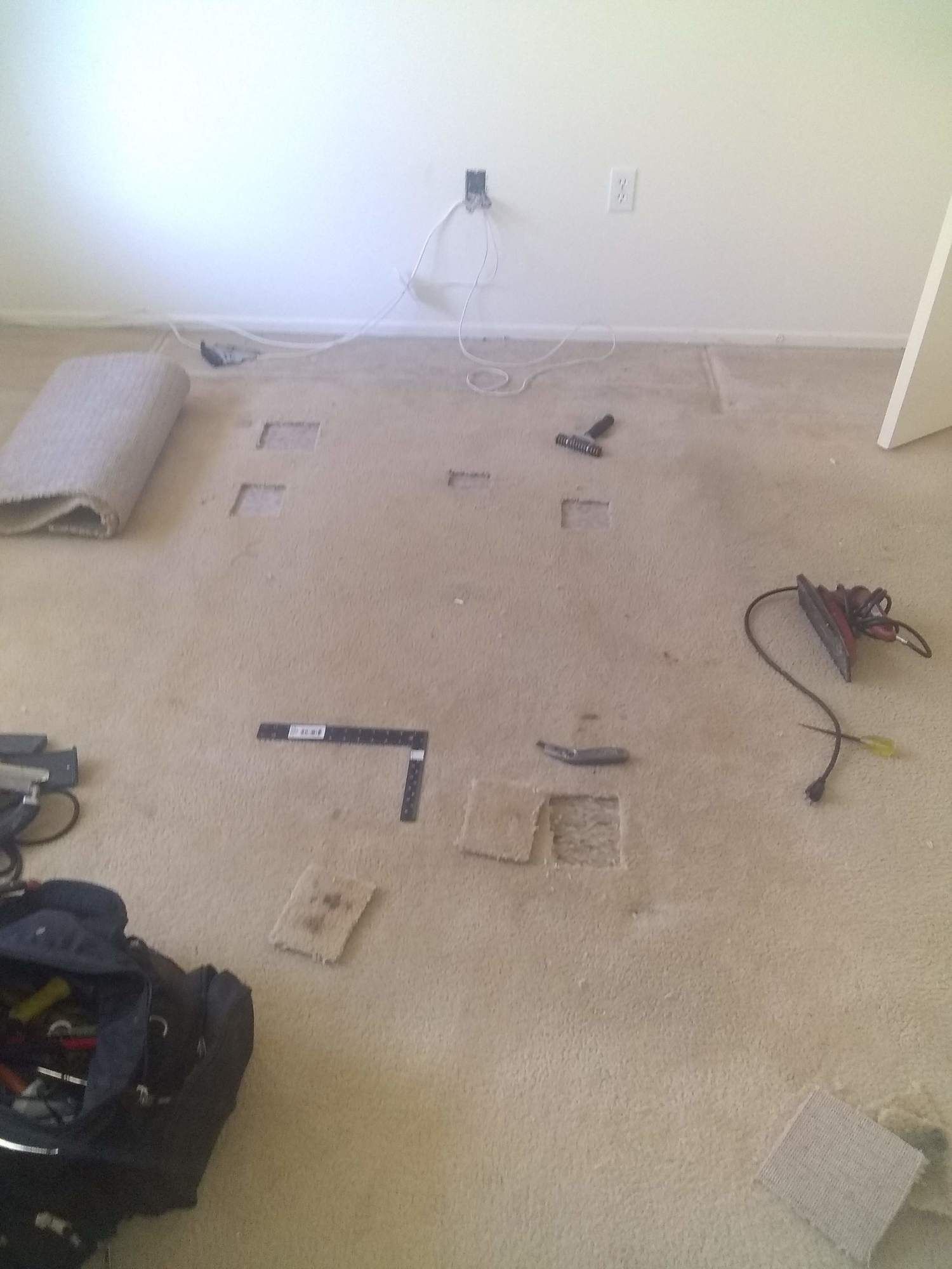 A room with a carpet and tools on the floor