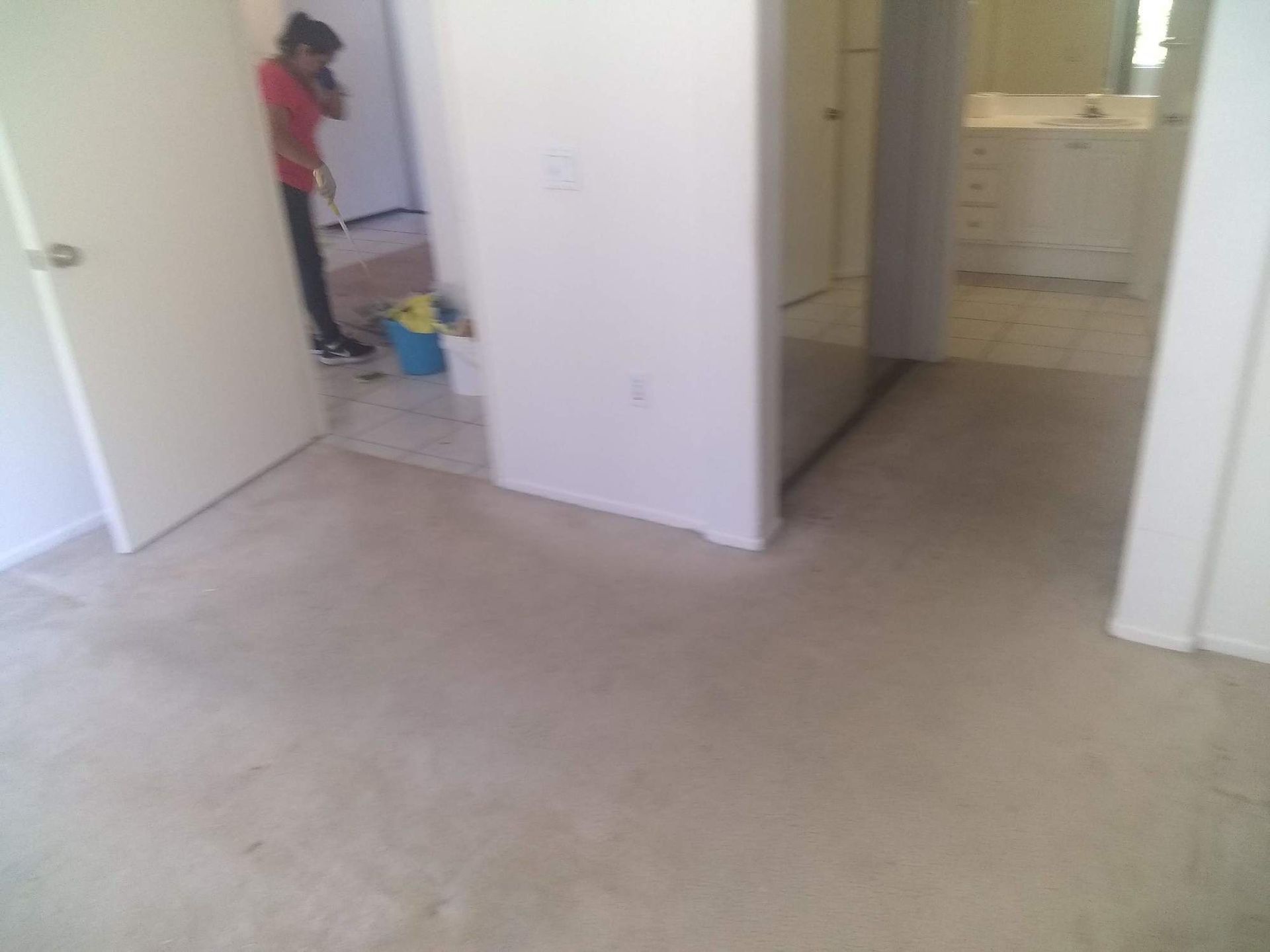 A person is standing in a hallway next to a bathroom