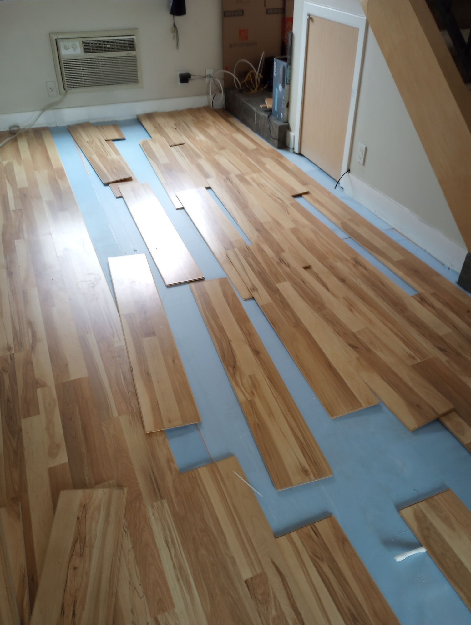 A room with a lot of wooden floors and a staircase