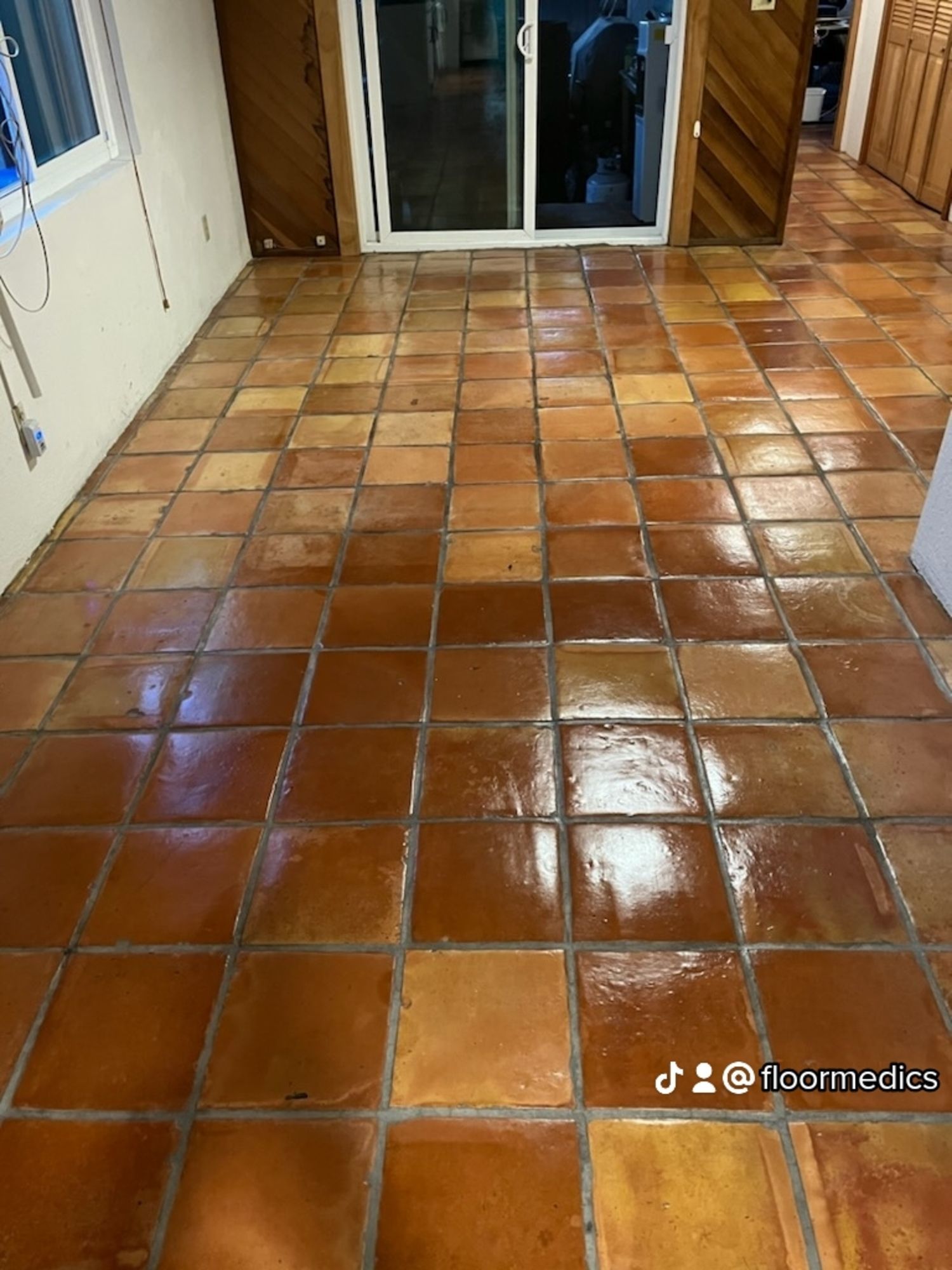A room with a tiled floor and a sliding glass door.