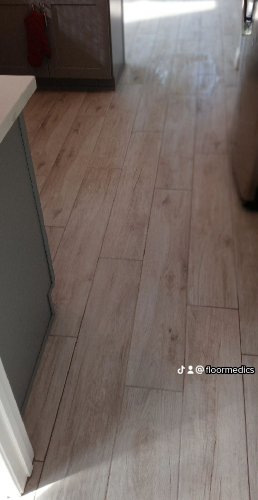 A kitchen with a wooden floor and a white counter top.
