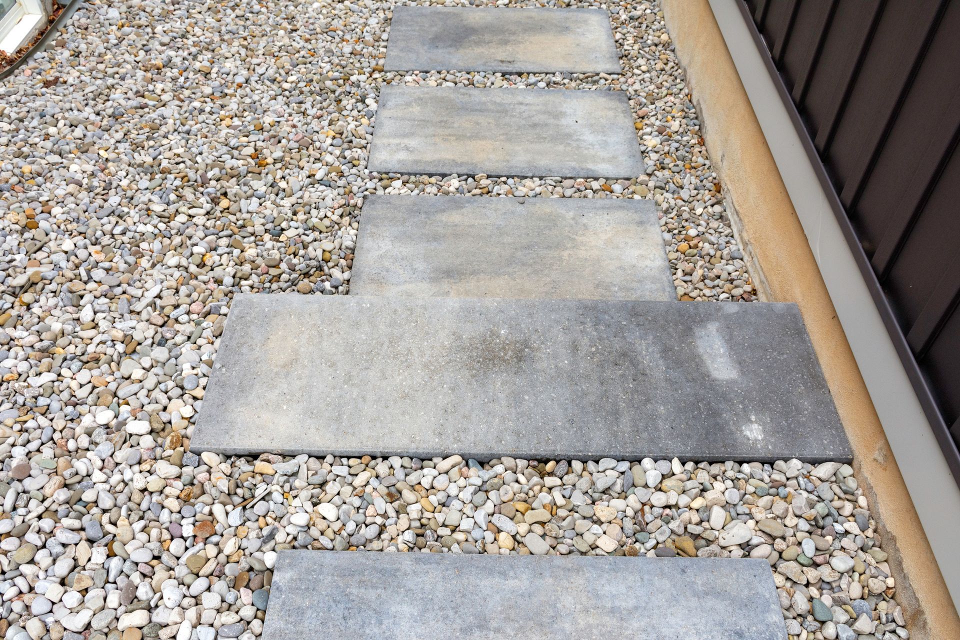 A Stone Walkway Is Lined Up On A Gravel Surface | North Alabama | Mattox Lawn Care & Landscaping