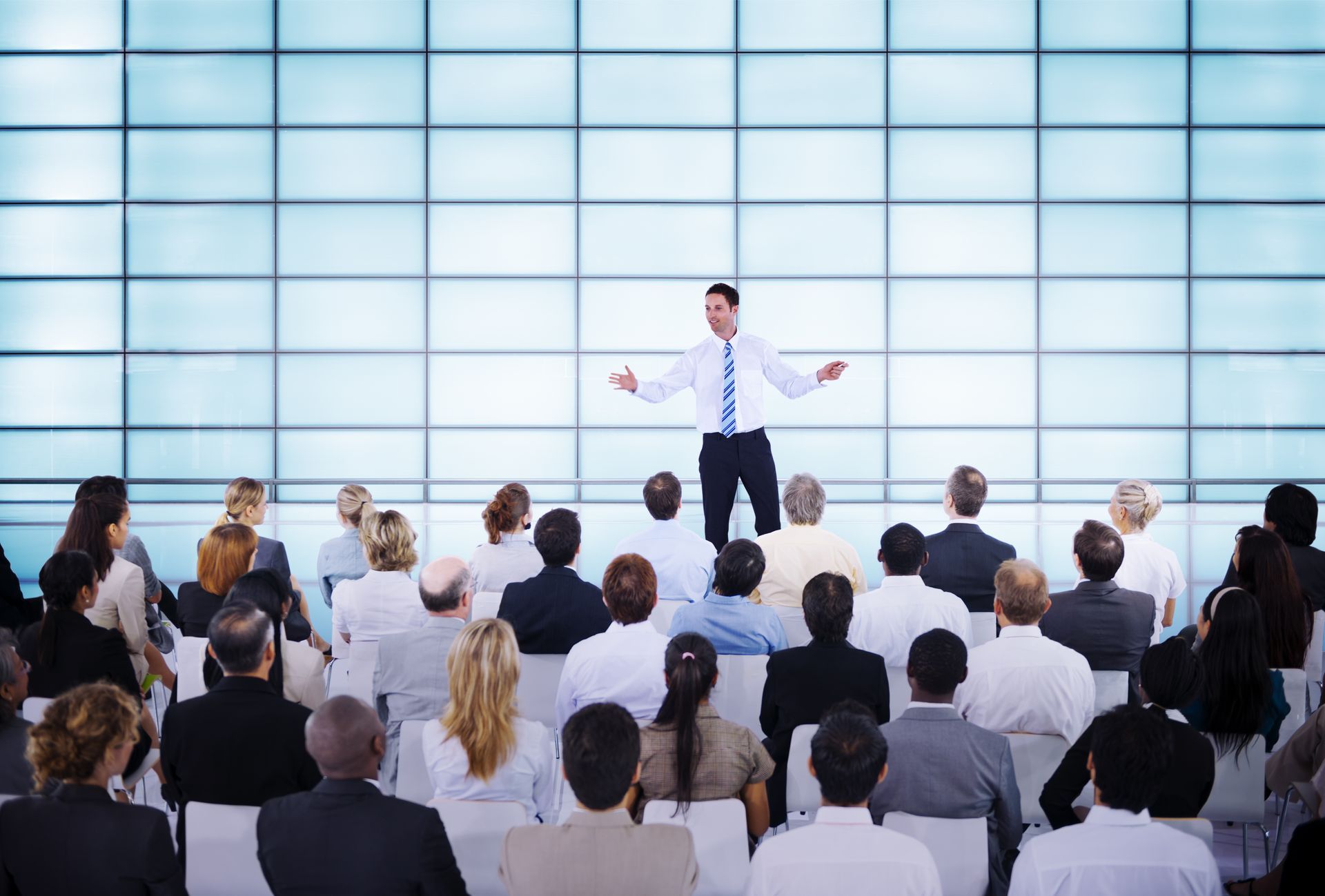 A man is giving a presentation to a group of people. 