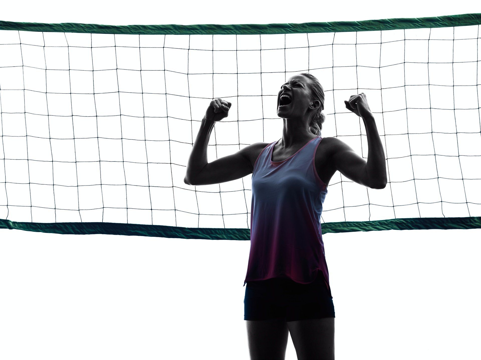 A woman is flexing her muscles in front of a volleyball net.