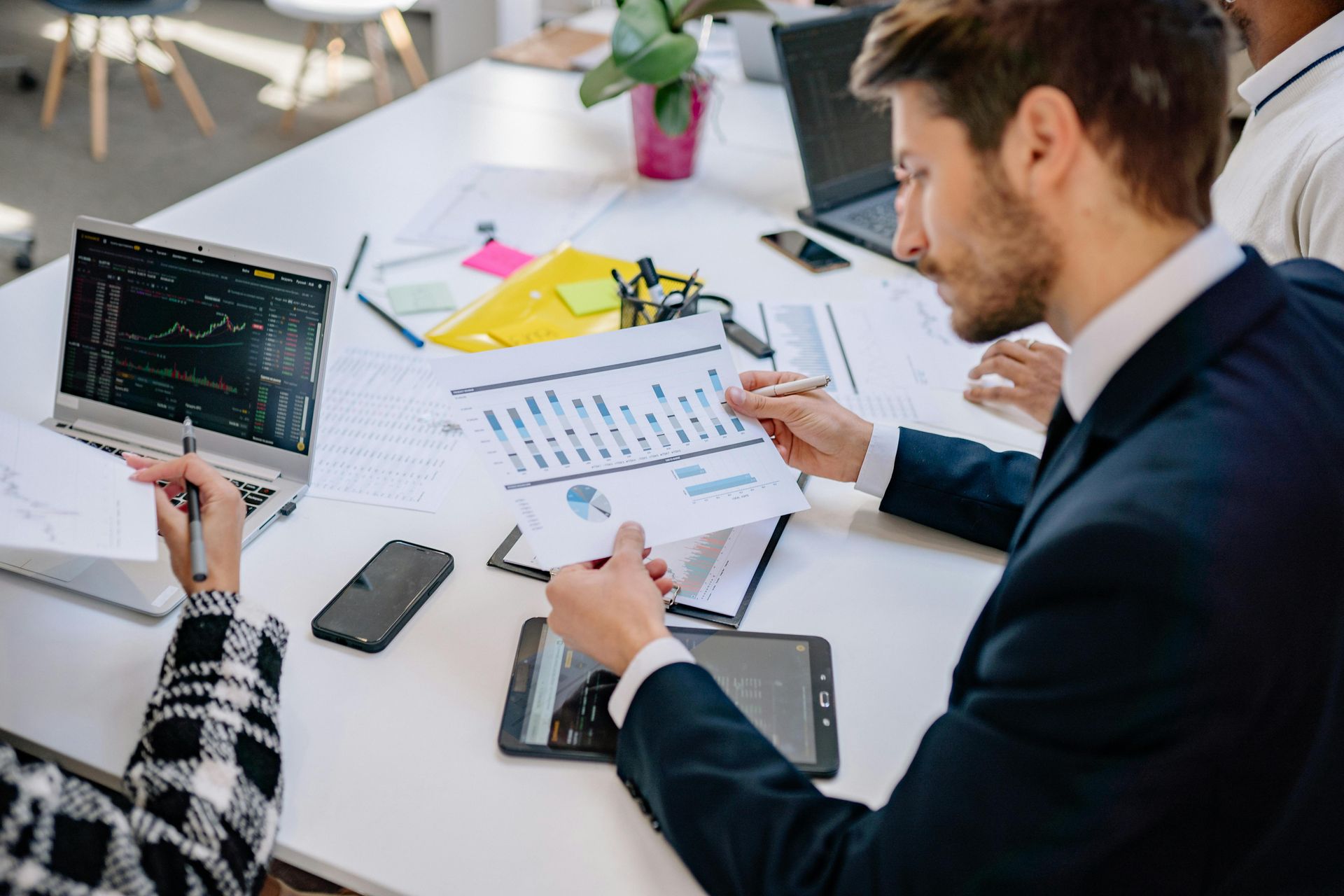 A photo of a man reviewing the financial graph.
