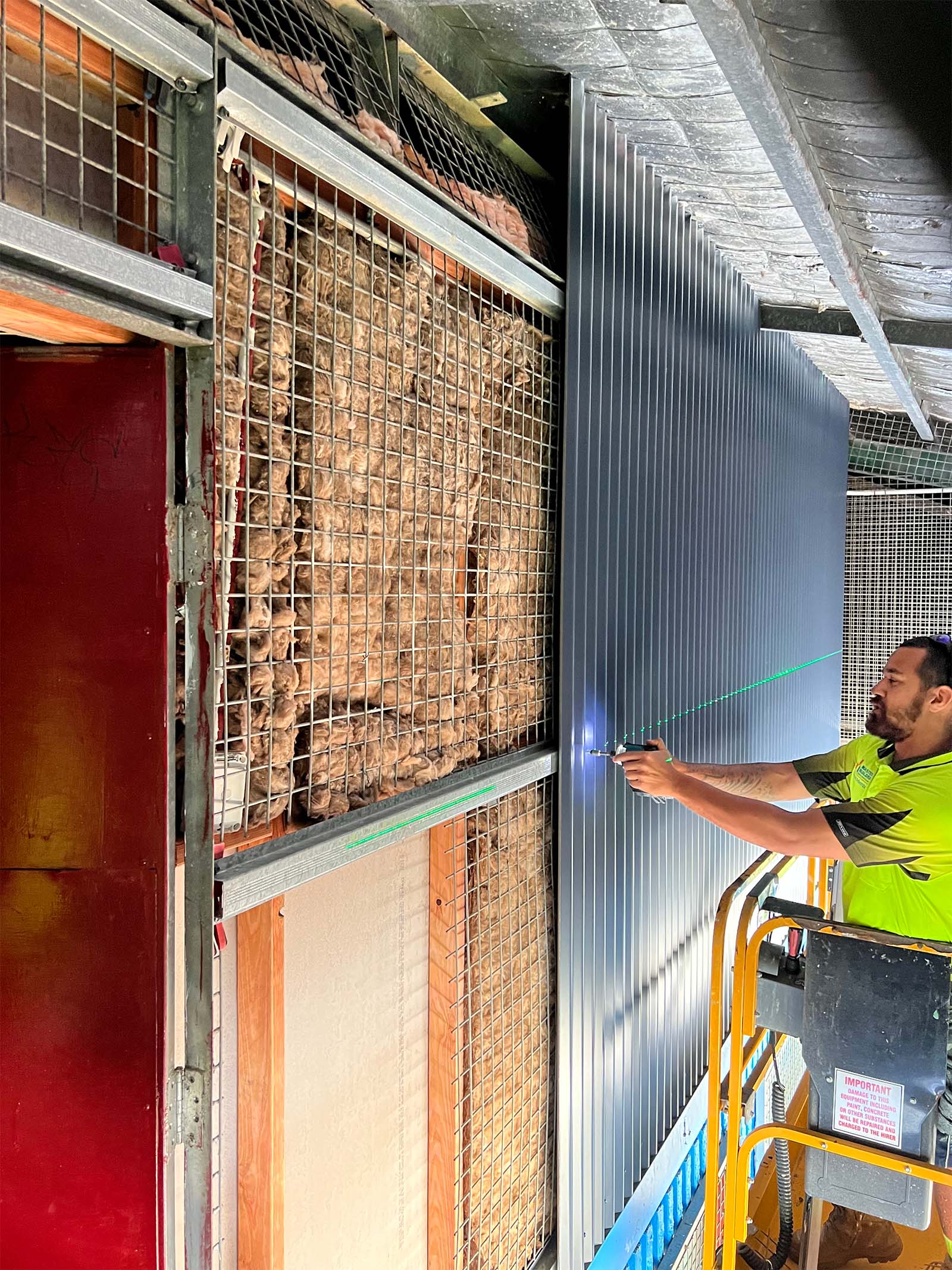 Carpenter Installing Colorbond Wall Lining In Cairns