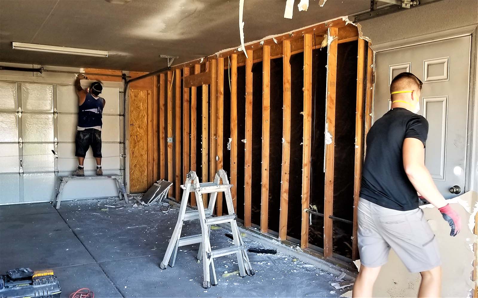 Courteous Carpenters Constructing A New Stud Wall In A Garage